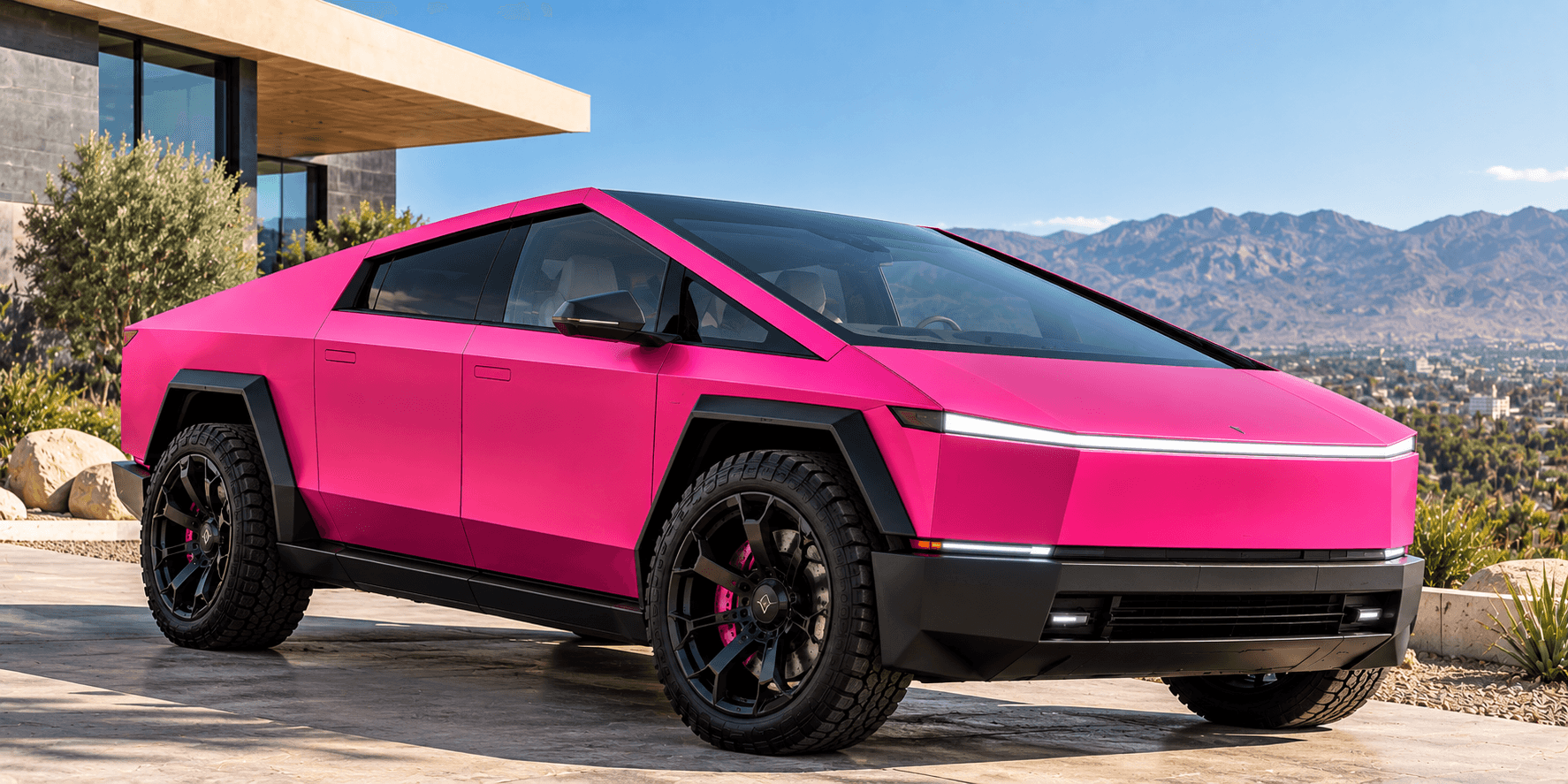Pink electric truck parked beside a coastal home